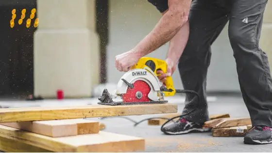 Man home improving by carving wooden planks